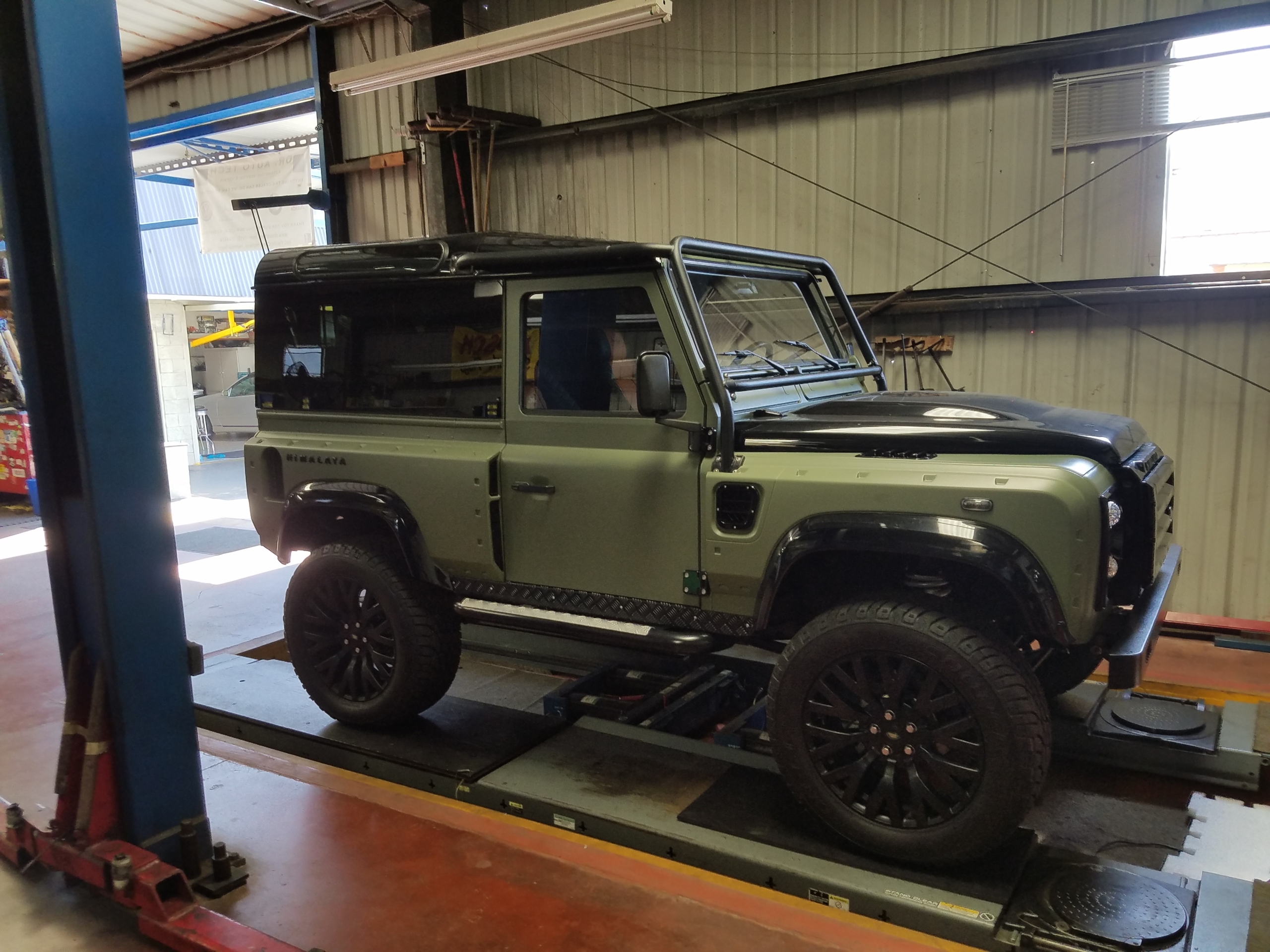 Land Rover Defender Service and Mechanical Repair Land Rover Defender positioned on a service rack at Dr Auto Tech in Hermosa Beach