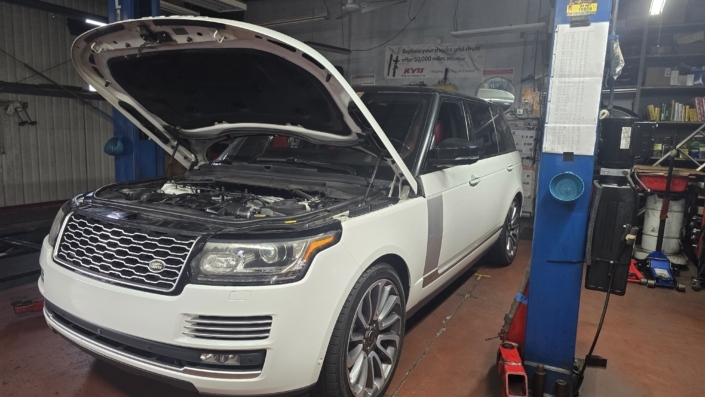 Range Rover Diagnostics, Maintenance and Repair White Range Rover with its hood open for diagnostics and repair at Dr Auto Tech