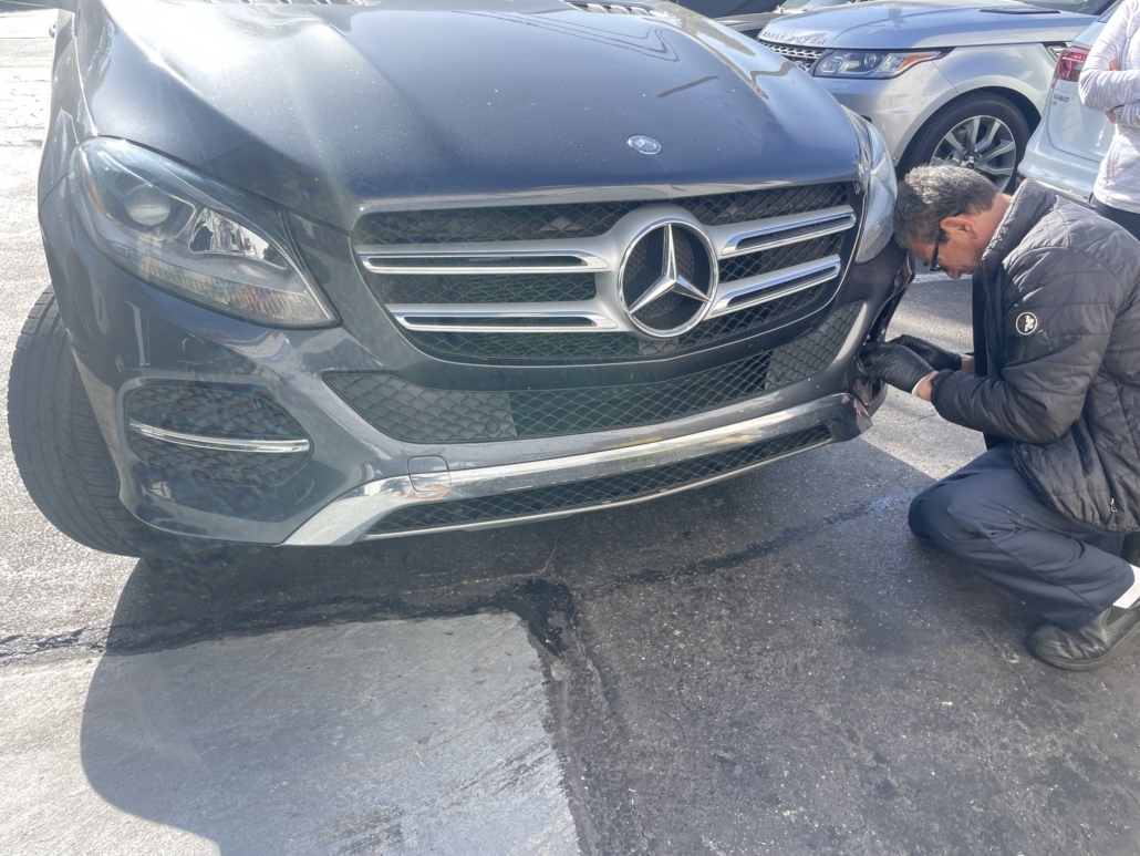 Master Technician Vasken visually inspecting the front exterior of a Mercedes-Benz in Hermosa Beach.